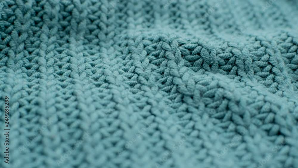 The texture of the fabric. Green knitted texture. Close-up. Can be used as a background. HD The texture of the fabric. Green knitted texture. Close-up. Can be used as a background. HD