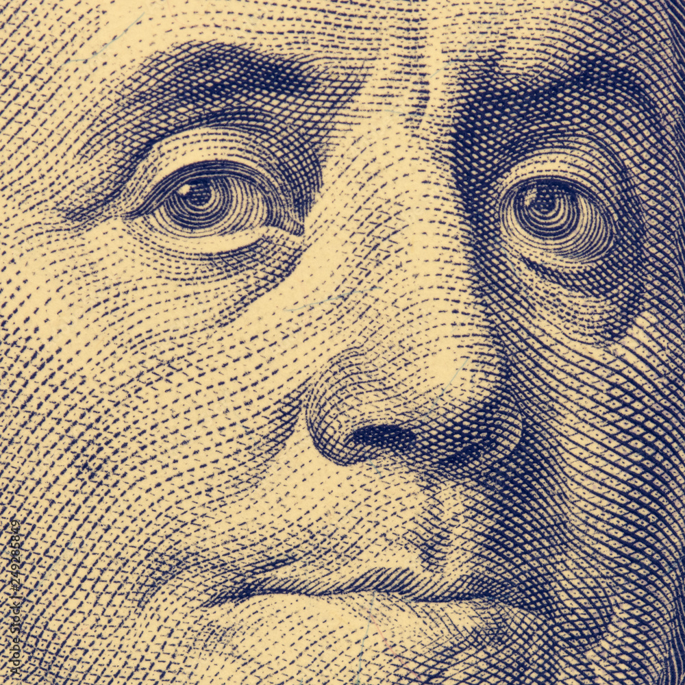 Fragment of hundred dollar bills. Franklin's face, square format, toned.
