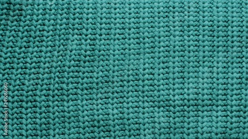 The texture of the fabric. Green knitted texture. Close-up. Can be used as a background. HD