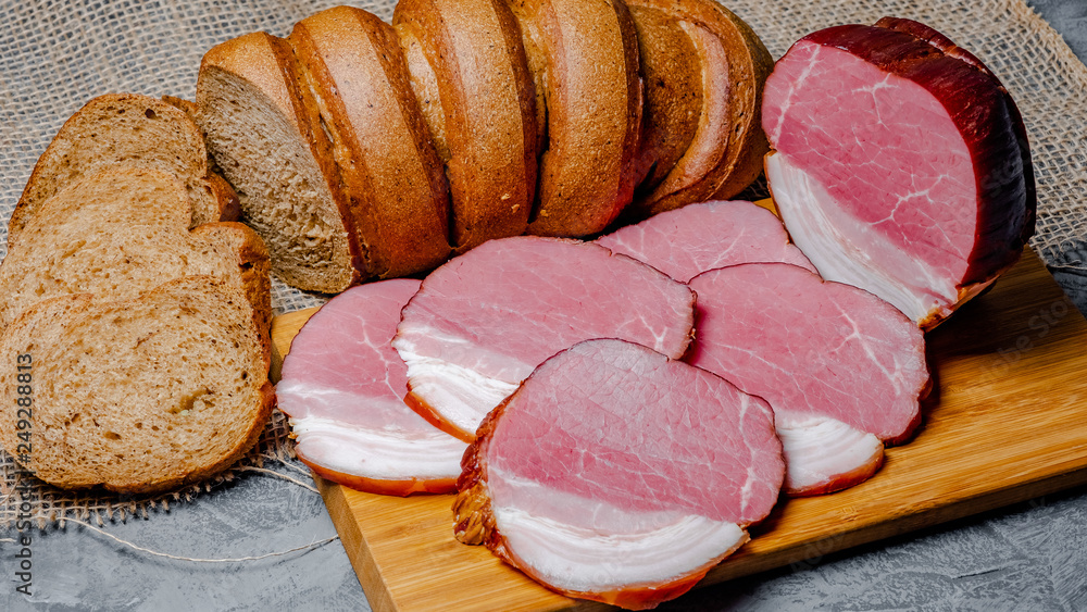 smoked meat and bread with bran on wooden background smoked meat and bread with bran on wooden background