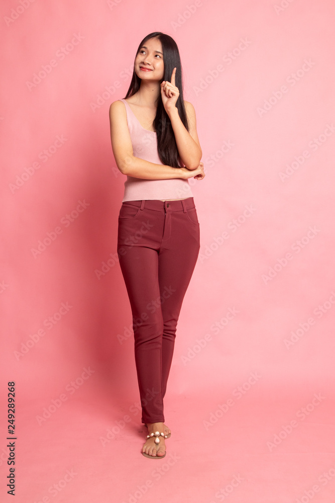 Full body of beautiful young asian woman pointing up. Full body of beautiful young asian woman pointing up.