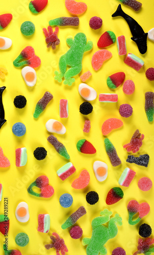 top view of jelly candies collection on yellow background