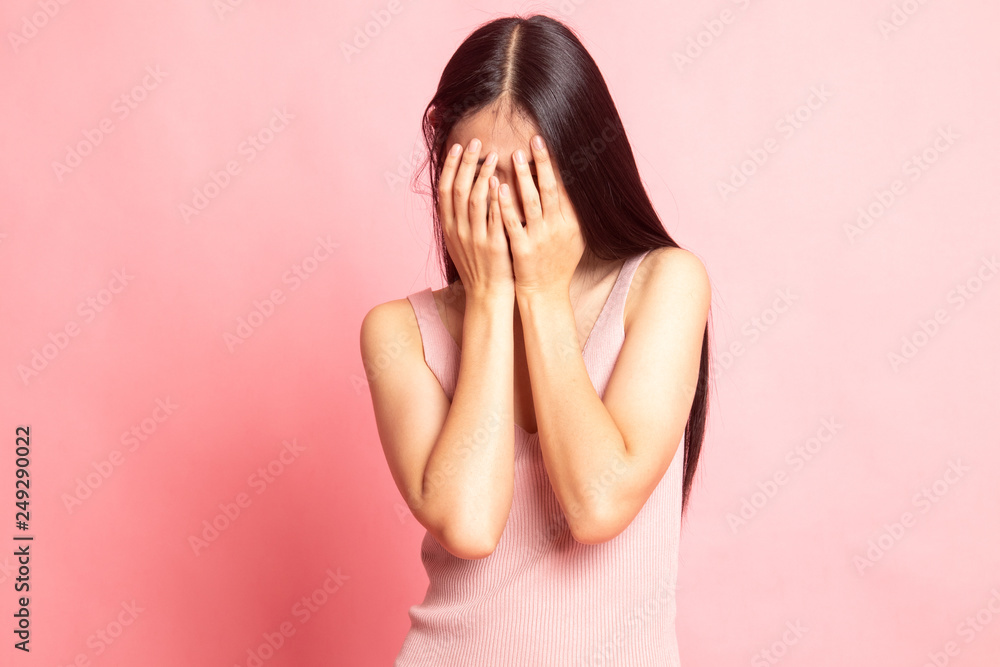 Sad young Asian woman cry with palm to face. Sad young Asian woman cry with palm to face.