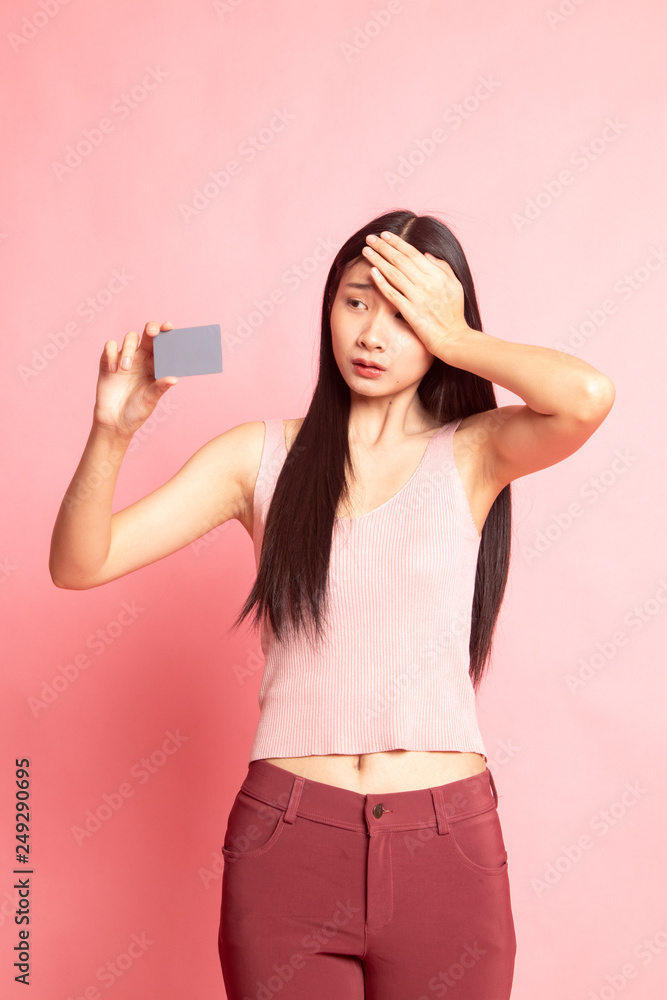 Young Asian woman headache with a blank card. Young Asian woman headache with a blank card.