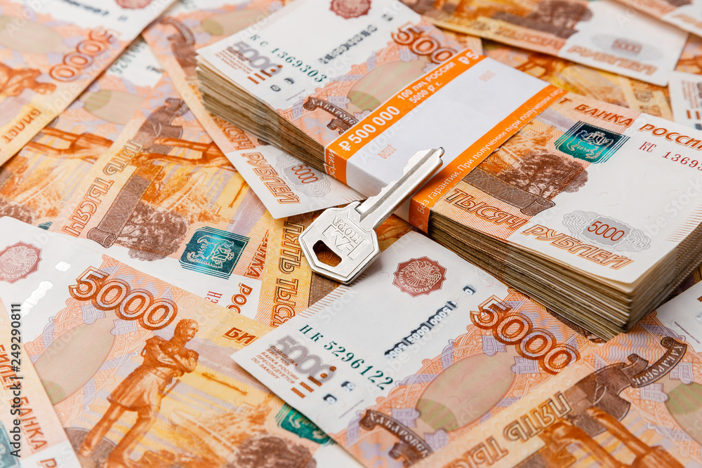 Key on stack of banknotes, many banknotes of five thousand Russian rubles as a background, packed stack of banknotes 5000 rubles, five hundred thousand Key on stack of banknotes, many banknotes of five thousand Russian rubles as a background, packed stack of banknotes 5000 rubles, five hundred thousand