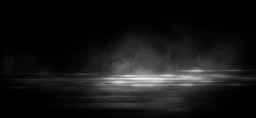 Wet asphalt, reflection of neon lights, a searchlight, smoke. Abstract light in a dark empty street with smoke, smog. Dark background scene of empty street, night view, night city.