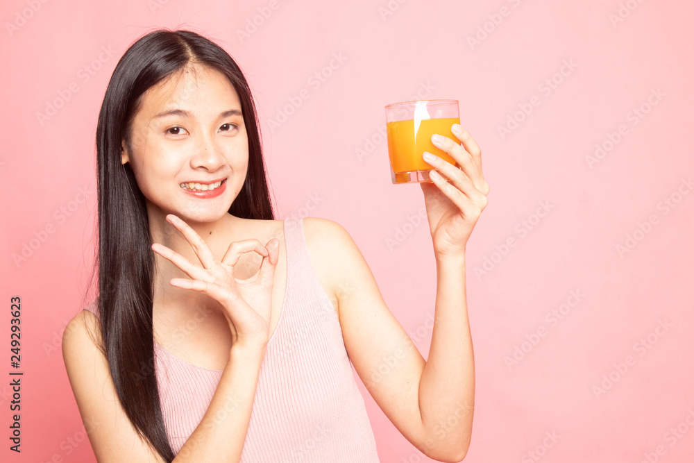 Young Asian woman show OK drink orange juice. Young Asian woman show OK drink orange juice.
