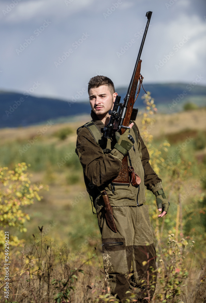 Man with rifle hunting equipment nature background. What you should have while hunting nature environment. Recharge rifle concept. Hunting equipment and safety measures. Prepare for hunting Man with rifle hunting equipment nature background. What you should have while hunting nature environment. Recharge rifle concept. Hunting equipment and safety measures. Prepare for hunting