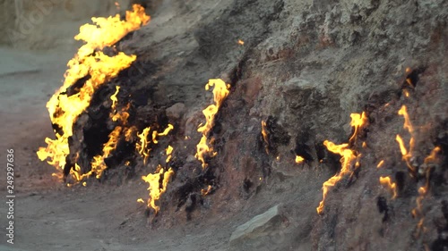 Natural burning ground. Burning natural gas from underground. photo