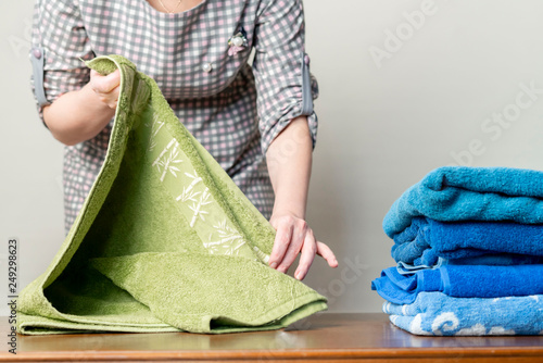 maid lays out the towels in the hotel