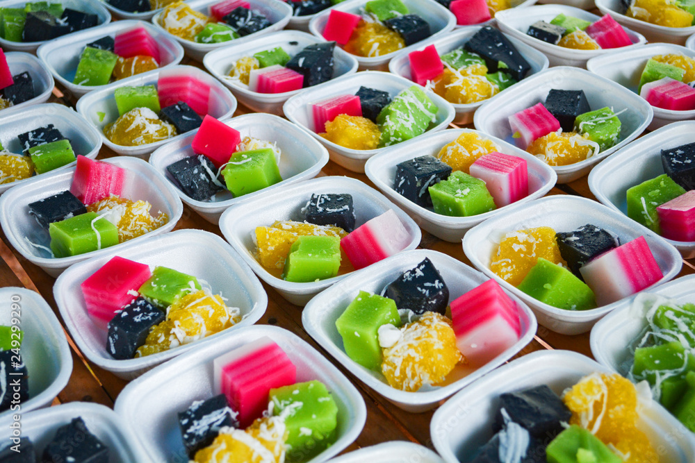 Thai colorful dessert set of in box with classy sweet , black and green coconut shredded pudding , steamed cassava yellow