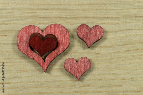 Laser cut wooden heart shape on light wood surface
