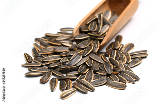 a scoop of sunflower seeds isolated on white background