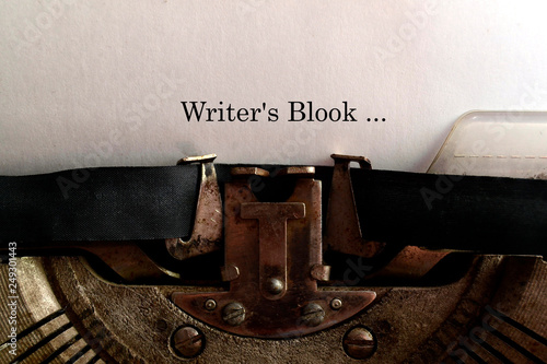 In the old typewriter inserted a white sheet of paper with the inscription: Writer's Blook ... photo