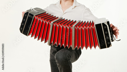 Tableau sur toile GOMEL, BELARUS - FEBRUARY 14, 2019: a bandoneon musical instrument in the hands of a musician