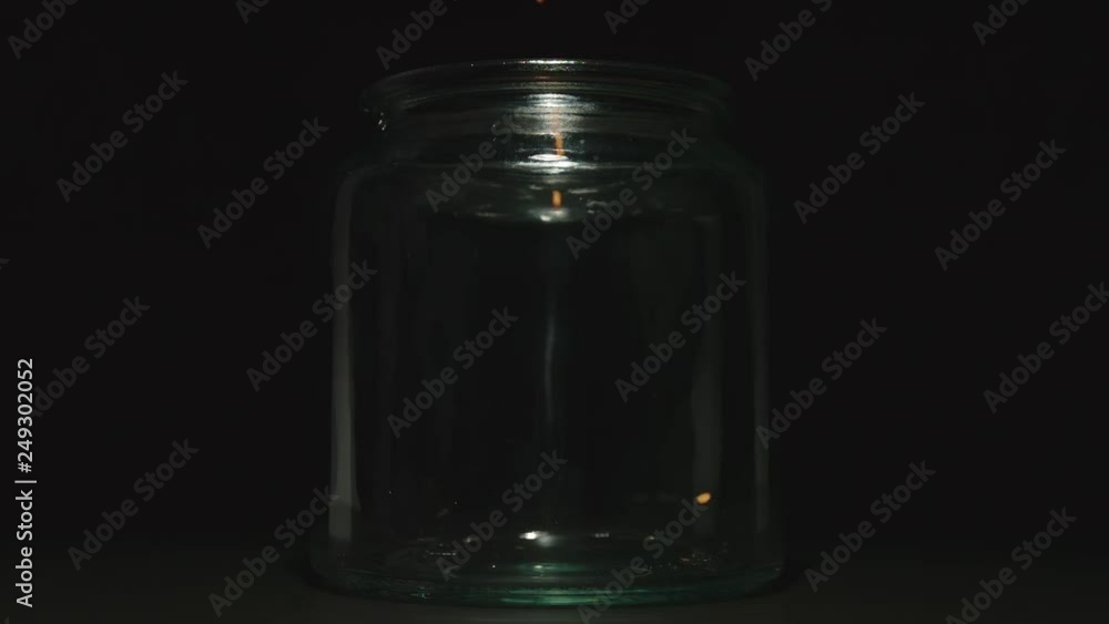 SLOW MOTION: Red lentils grains falling into a glass jar SLOW MOTION: Red lentils grains falling into a glass jar