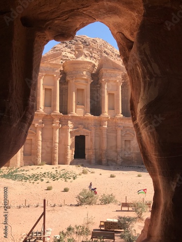 Evocative view of the monastery from a natural rock frame, Petra, Jordan