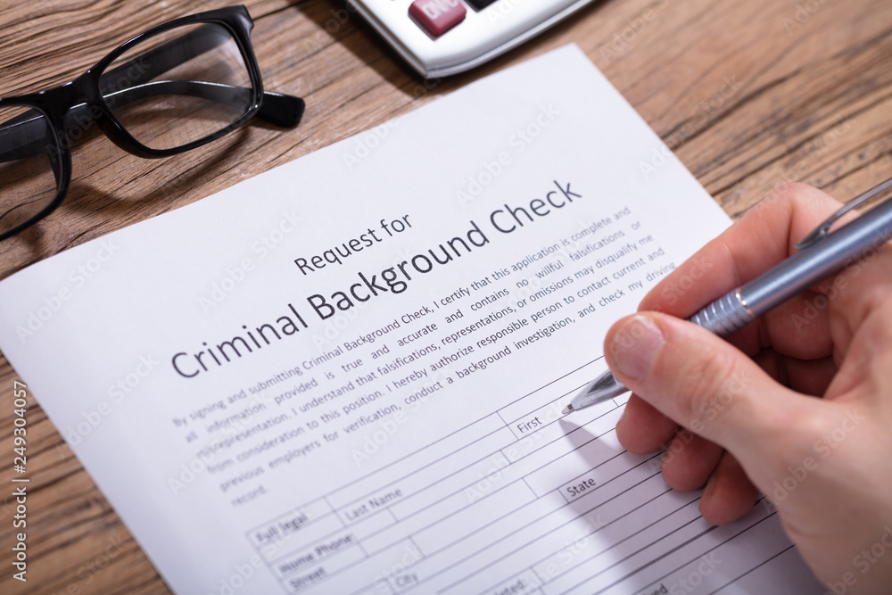 Obraz premium Person Filling Criminal Background Check Form
