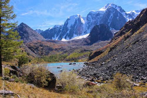 Mountain lake in autumn on the background of snow-white peaks