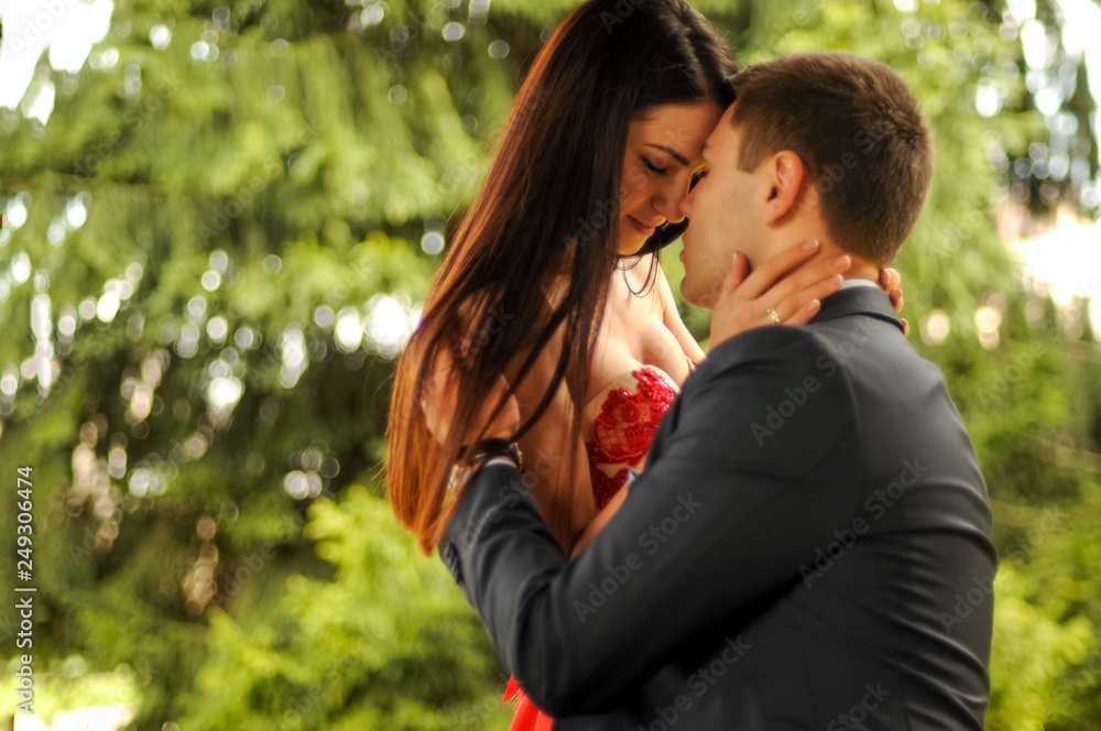 Close up romantic couple are hugging and enjoy each other in the park outdoor Close up romantic couple are hugging and enjoy each other in the park outdoor