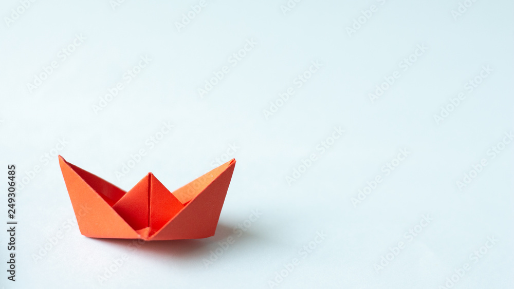 Red paper ship on light blue background.Idea Concept. Red paper ship on light blue background.Idea Concept.
