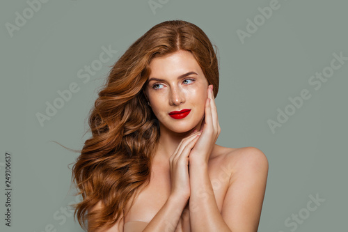 Red head girl. Beautiful ginger hair and red lips makeup. Perfect red haired woman portrait