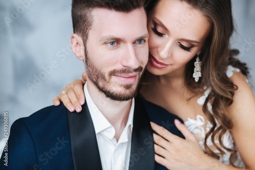 Wedding couple hugging each other indoor.Close-up portrait of wedding couple . Beauty bride with groom.