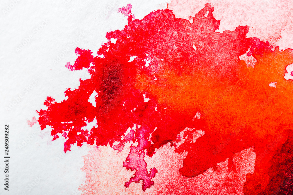 top view of red watercolor spill on white paper top view of red watercolor spill on white paper