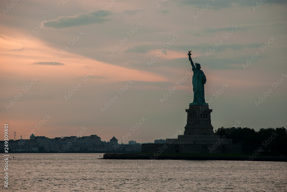 Silhouette of Statue of Liberty at beautiful sunset Silhouette of Statue of Liberty at beautiful sunset