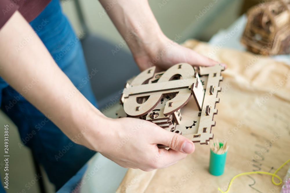 young man hold concept of mini bank safe with dollar icon b