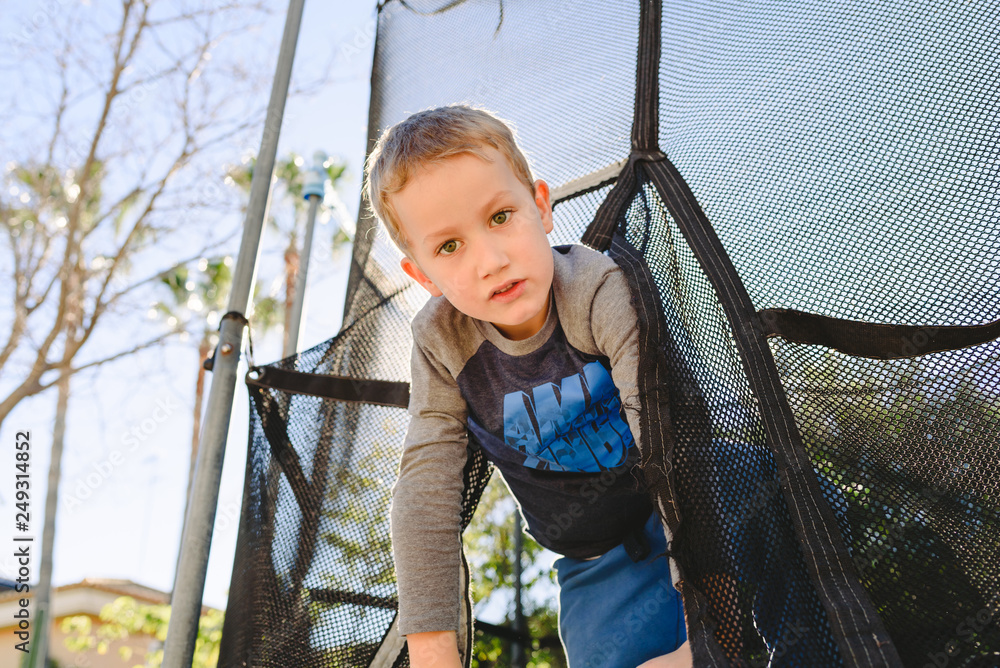 Child having fun in summer on a trampoline at sunset. Child having fun in summer on a trampoline at sunset.