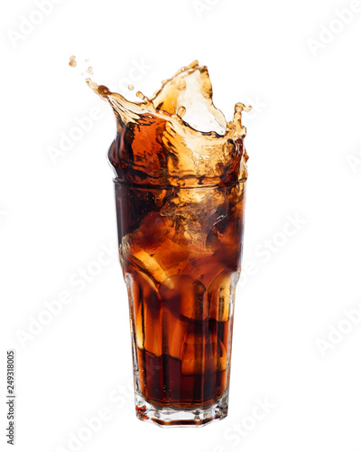 Cola splashing out of a glass isolated on white background.