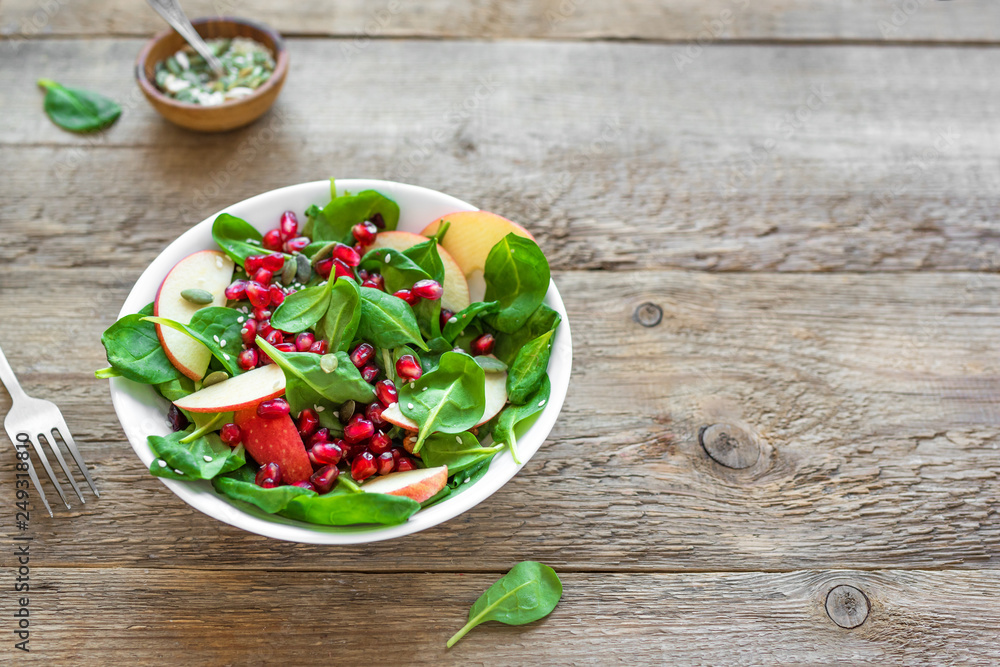 Spinach, apple salad with pomegranate seeds Spinach, apple salad with pomegranate seeds