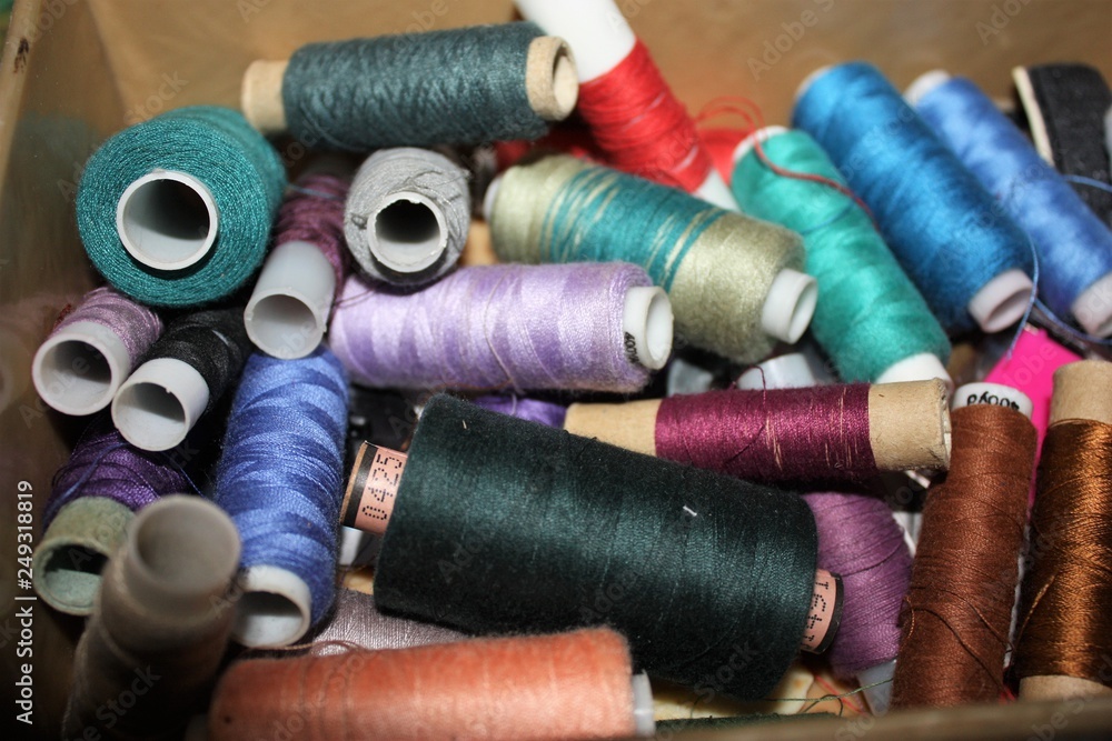 Closeup Group of colorful spools of thread use to sewing, needlework and embroidery Closeup Group of colorful spools of thread use to sewing, needlework and embroidery