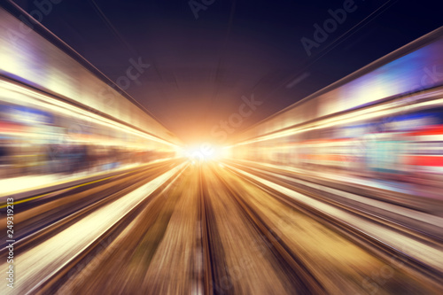 Motion blur movement through the city at night by train