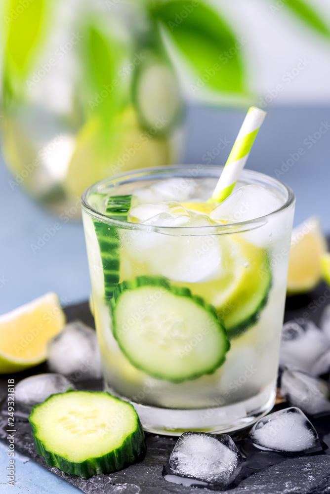 Cold and Refreshing Infused Detox Water with Lime and Cucumber in a Glass With Ice Cube Healthy Detox Drink Vertical Cold and Refreshing Infused Detox Water with Lime and Cucumber in a Glass With Ice Cube Healthy Detox Drink Vertical