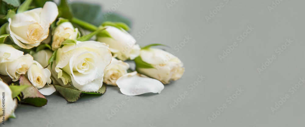 Roses bouquet on grey background with copy space, beautiful delicate roses flowers bouquet