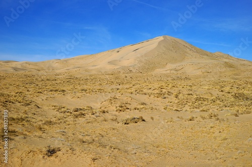Kelso Dunes peak view over bright blue sky
