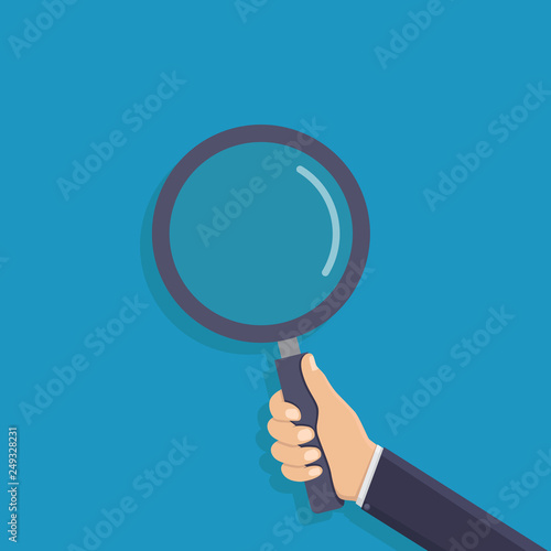 Business hand holding a magnifying glass, flat design vector illustration