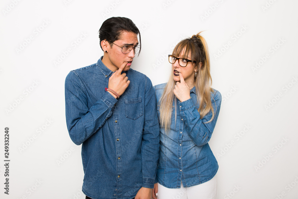 Young couple with glasses having doubts while looking up Young couple with glasses having doubts while looking up