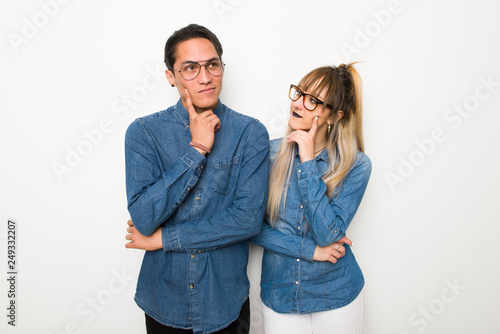 Young couple with glasses thinking an idea while looking up