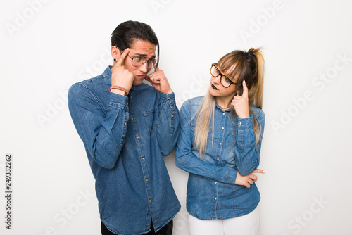 Young couple with glasses having doubts and thinking