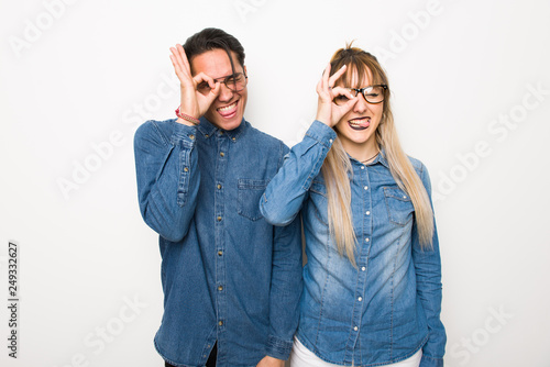 Young couple with glasses makes funny and crazy face emotion