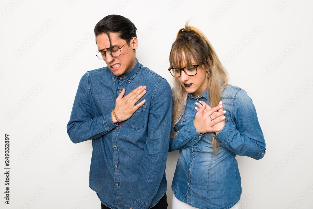 Young couple with glasses having a pain in the heart Young couple with glasses having a pain in the heart