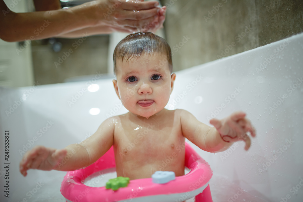 A little girl makes a happy bath with her mother. A little girl makes a happy bath with her mother.
