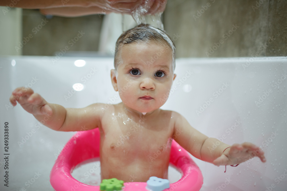 A little girl makes a happy bath with her mother. A little girl makes a happy bath with her mother.