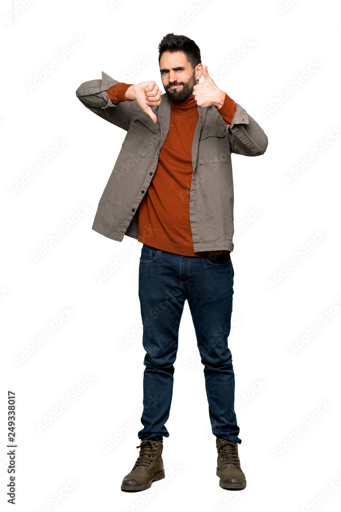 Full-length shot of Handsome man with beard making good-bad sign. Undecided between yes or not on isolated white background Full-length shot of Handsome man with beard making good-bad sign. Undecided between yes or not on isolated white background