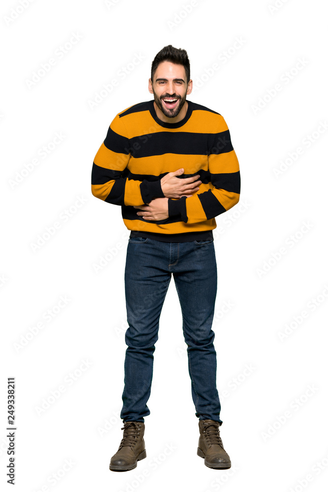 Full-length shot of Handsome man with striped sweater smiling a lot while putting hands on chest on isolated white background Full-length shot of Handsome man with striped sweater smiling a lot while putting hands on chest on isolated white background