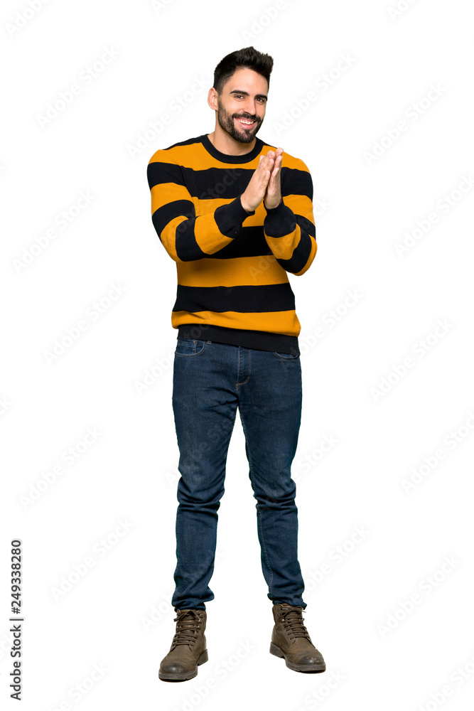 Full-length shot of Handsome man with striped sweater applauding after presentation in a conference on isolated white background Full-length shot of Handsome man with striped sweater applauding after presentation in a conference on isolated white background