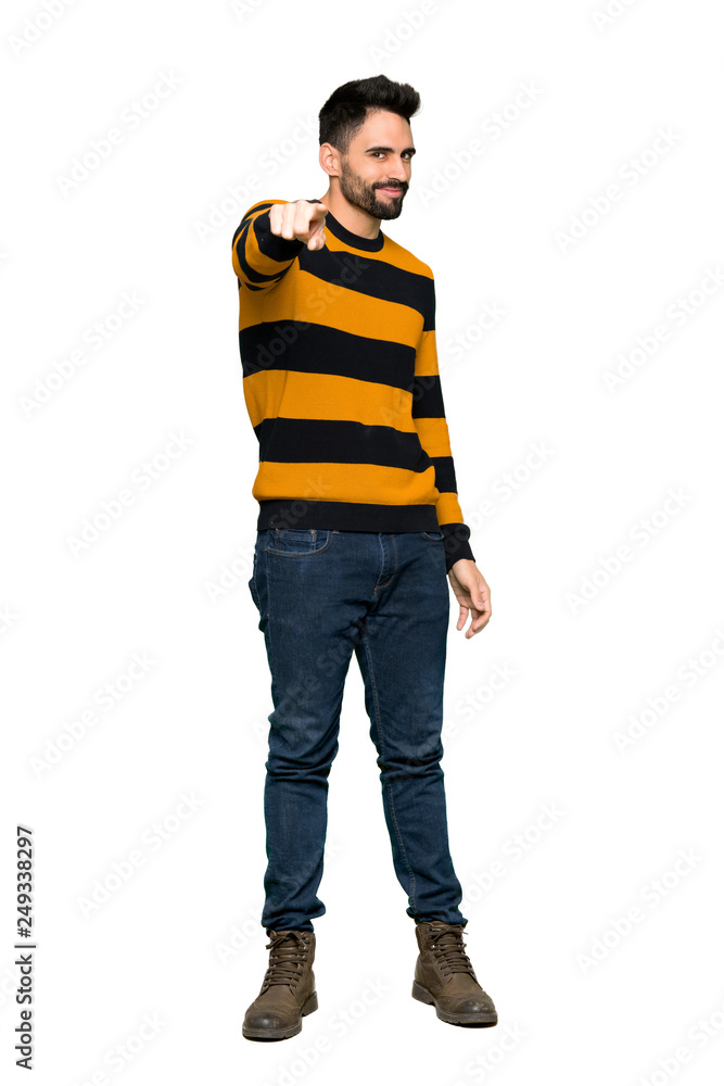 Full-length shot of Handsome man with striped sweater points finger at you with a confident expression on isolated white background Full-length shot of Handsome man with striped sweater points finger at you with a confident expression on isolated white background